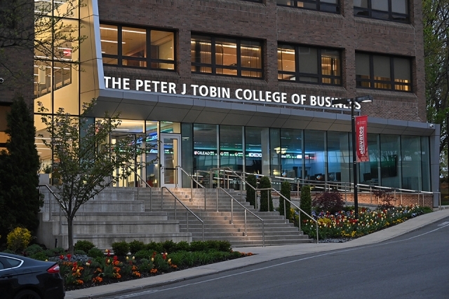 The Peter J. Tobin College of Business building in the evening