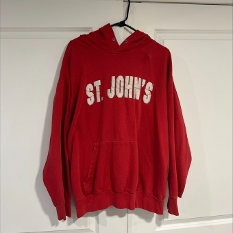 St. John's University red hoodie hanging in closet