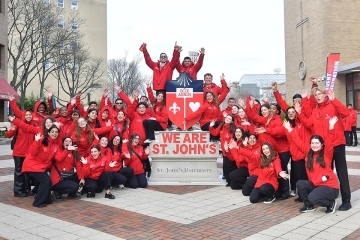 SJU Student Ambassadors posing infront of St. John's logo