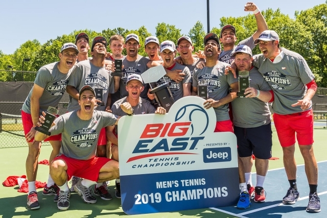 2019 St. John's Tennis Team poses with Championship banner