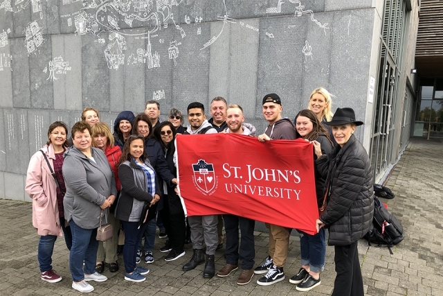 Alumni and Friends in Ireland holding a St. John's banner