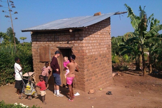 People outside a structure in Uganda