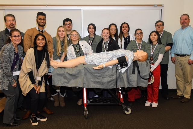 Students posing infront of simulation dummy