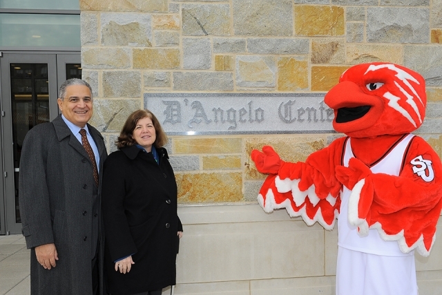 Johnny Thunderbird and couple posing for a photo in front of D'Angelo Center