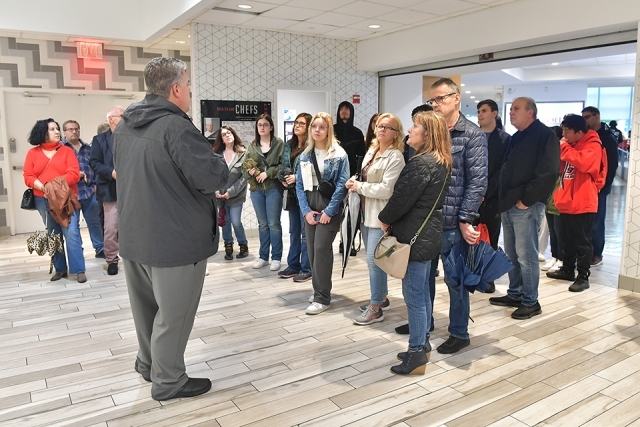 St. John's campus tour stops inside the Peter J. Tobin College of Business building lobby