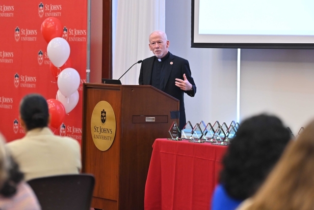 Fr. Shanley speaking at the podium at the 2024 Training and Development Certificate Graduation