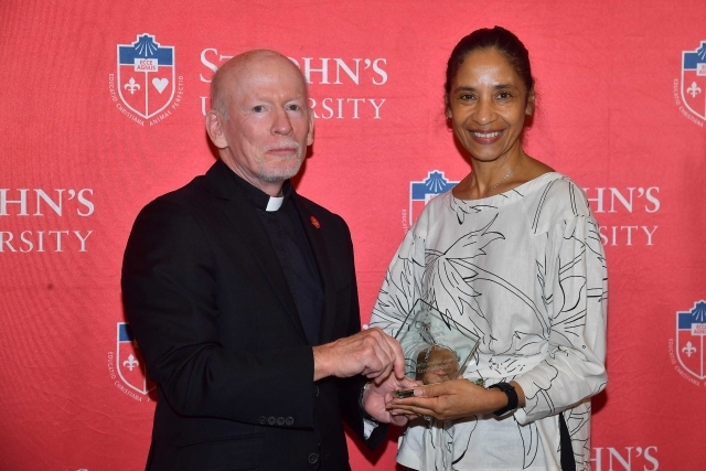 Fr. Shanley handing award to 2024 Training and Development Certificate Graduate