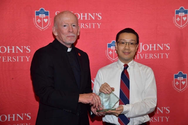 Fr. Shanley handing award to 2024 Training and Development Certificate Graduate