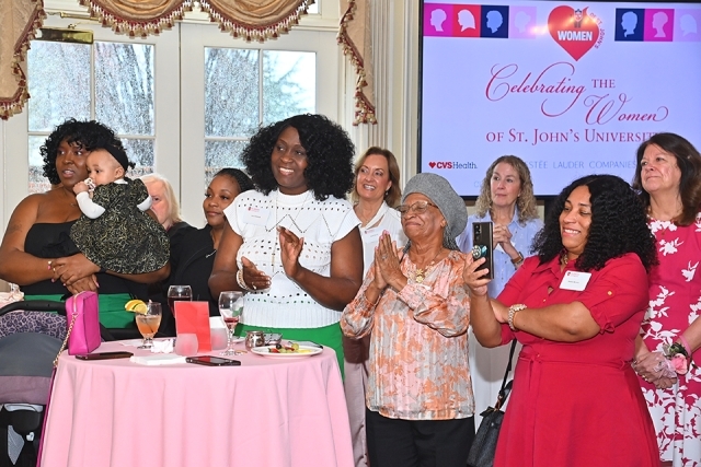 Group of females clapping at St. John's Women's luncheon