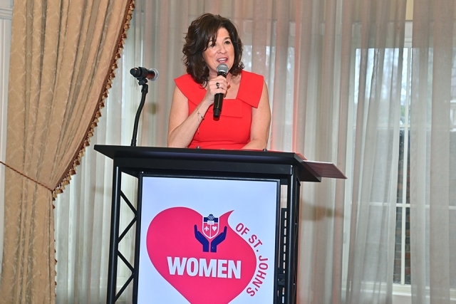 Kathy Meehan speaking at podium at the St. John's Women's luncheon