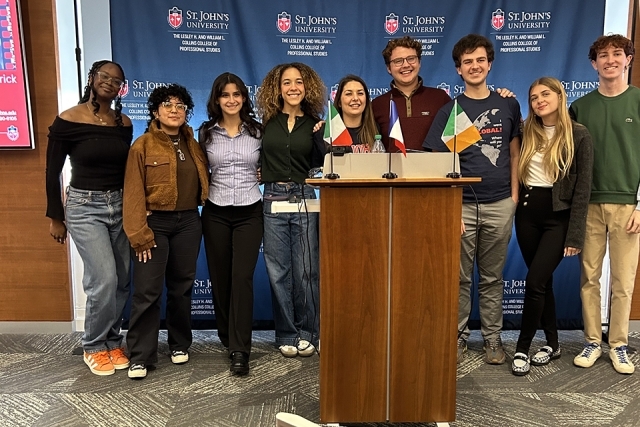 Students posing for a photo at a podium