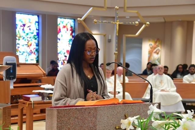 St. John's community member speaking at podium in church