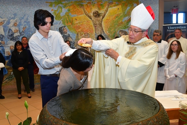 woman being baptized by Bishop