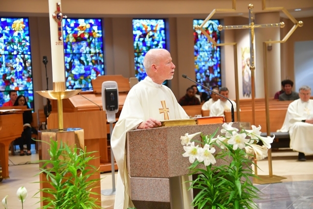 Fr. Shanley speaking at podium in church