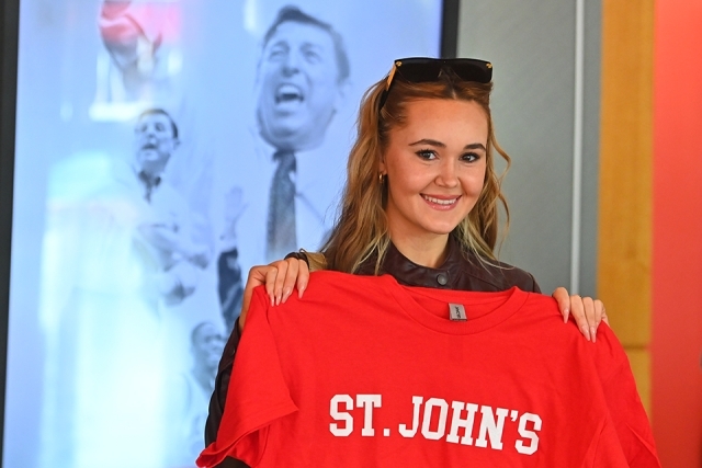 A student holding a St. John's tshirt