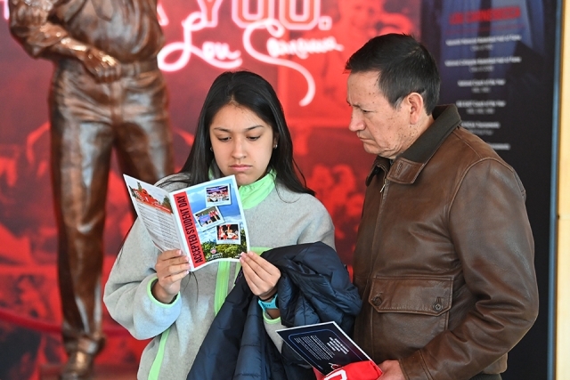 Female student with family member reading St. John's brochure