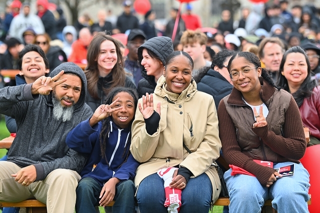 A St. John's accepted student and her family sitting on the Great Lawn