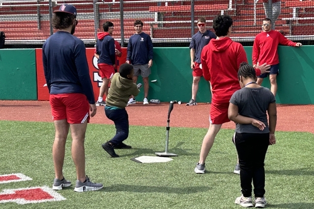 St. John's baseball team with special needs children on the field