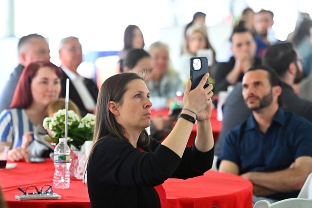 Table of Staten Island Closing Celebration attendee taking a picture on her phone