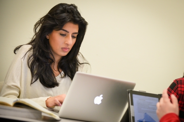 Female student using Mac laptop