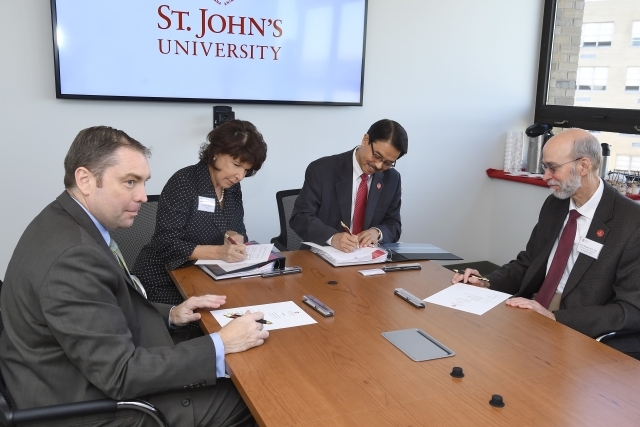 St. John's University signing an articulation agreement with Queensborough Community College