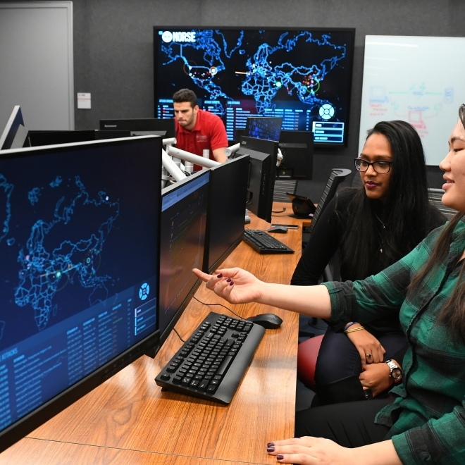 Three students working on computers in SJU Cyber Security Lab