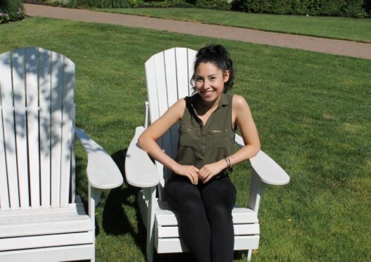 Nicole Ariza sitting in Adirondack chair 