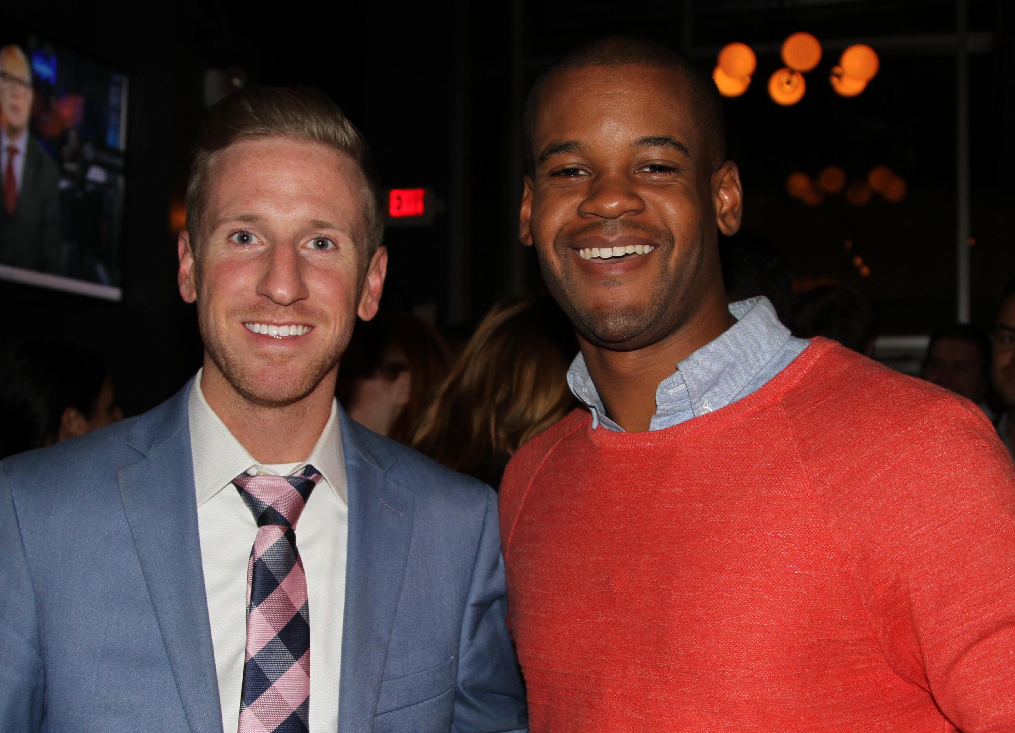 Two males posing for photo in bar