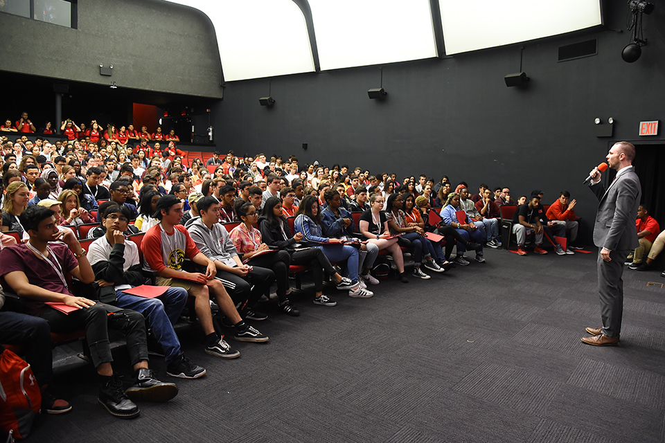 Speaker in front of assembled new students