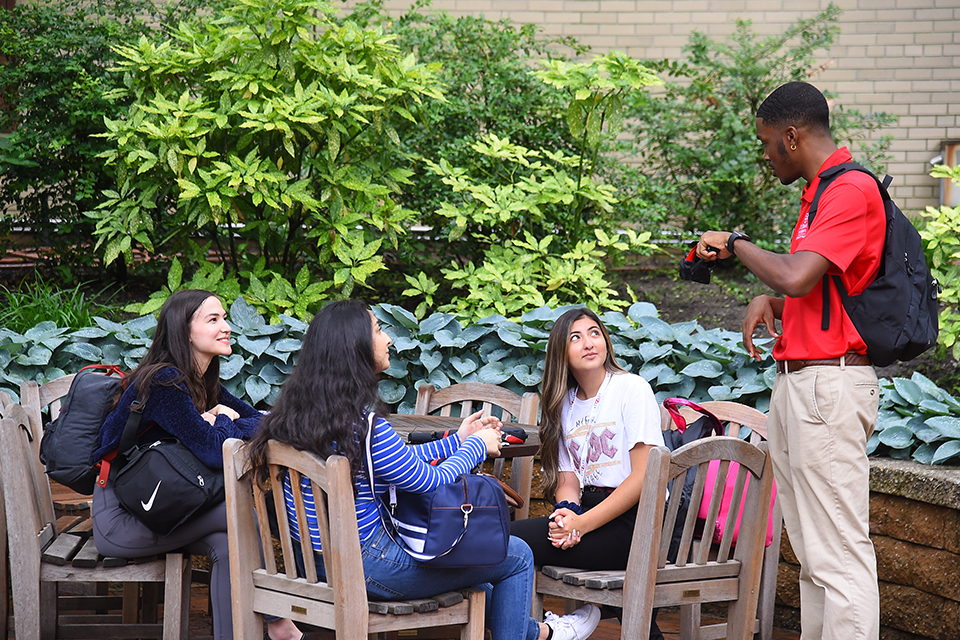 Orientation leader speaking with new students