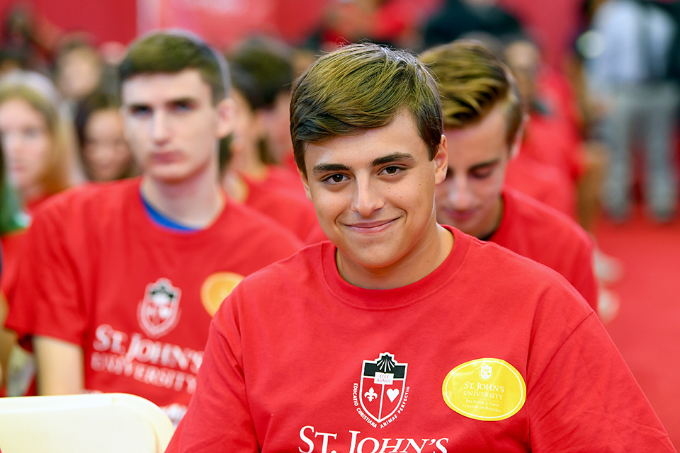 Group of students sitting at ceremony smiling