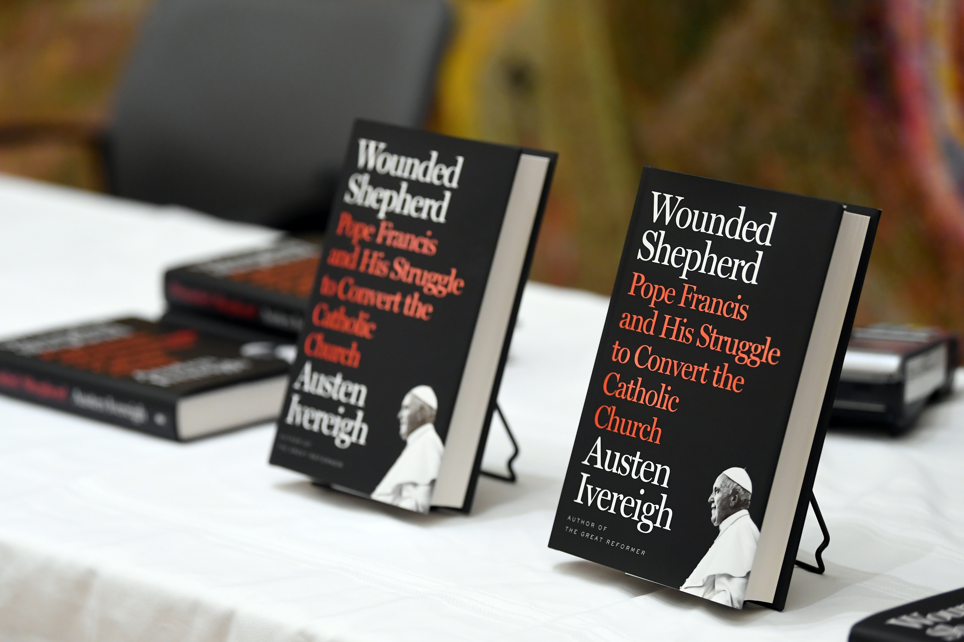 Two copies of books in stands on a table
