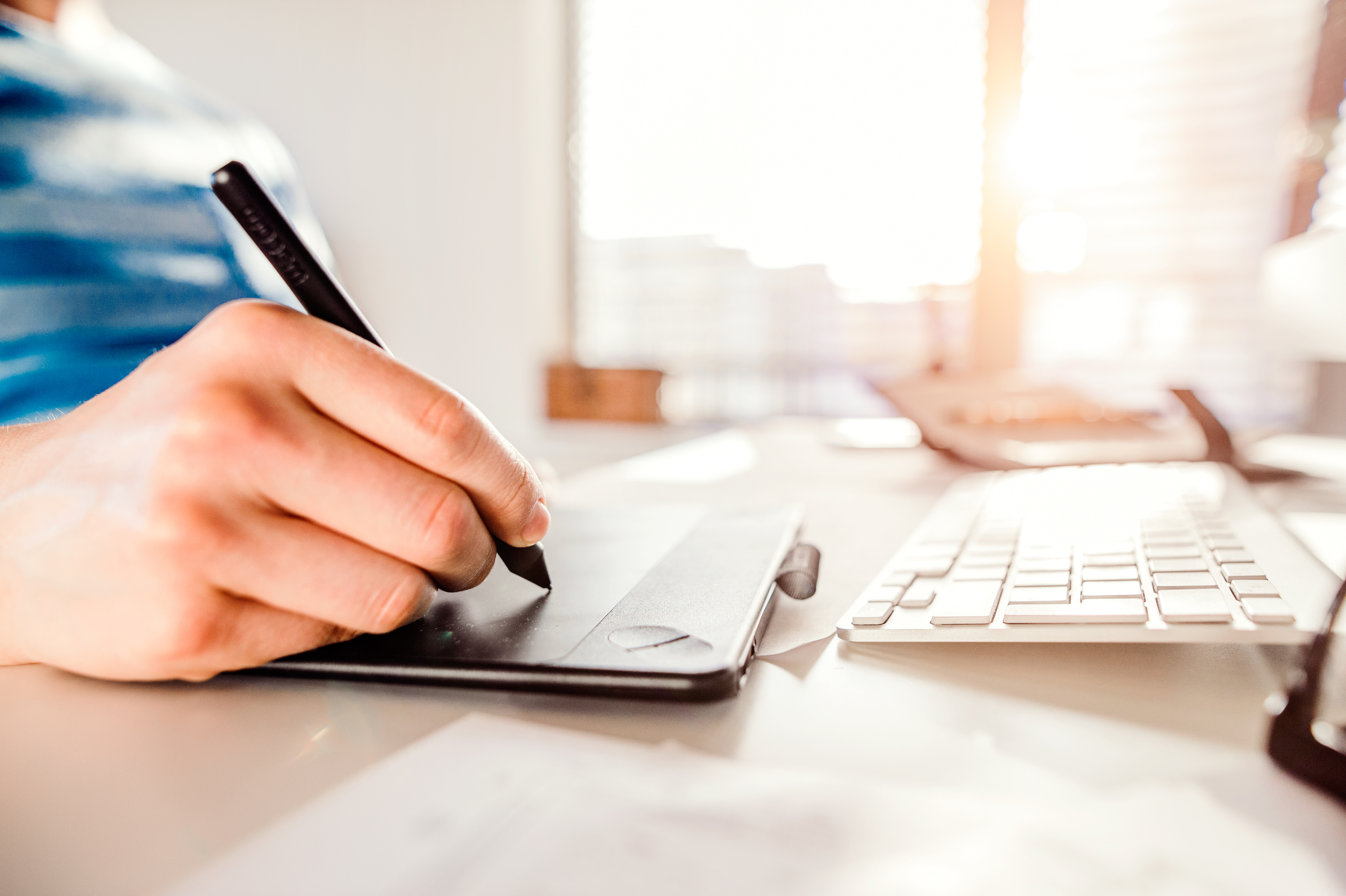 Person's hand working from home