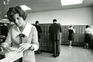 woman searching in a card catalog
