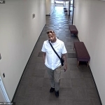 Man walking through hallway as seen from ceiling video