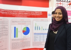 Female student standing infront of her research poster