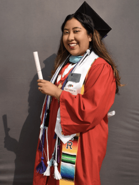 Elvira Garcia poses for a picture in her cap and gown