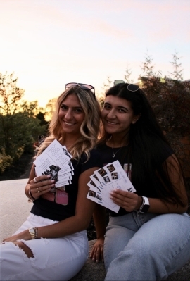 A couple of women holding papers