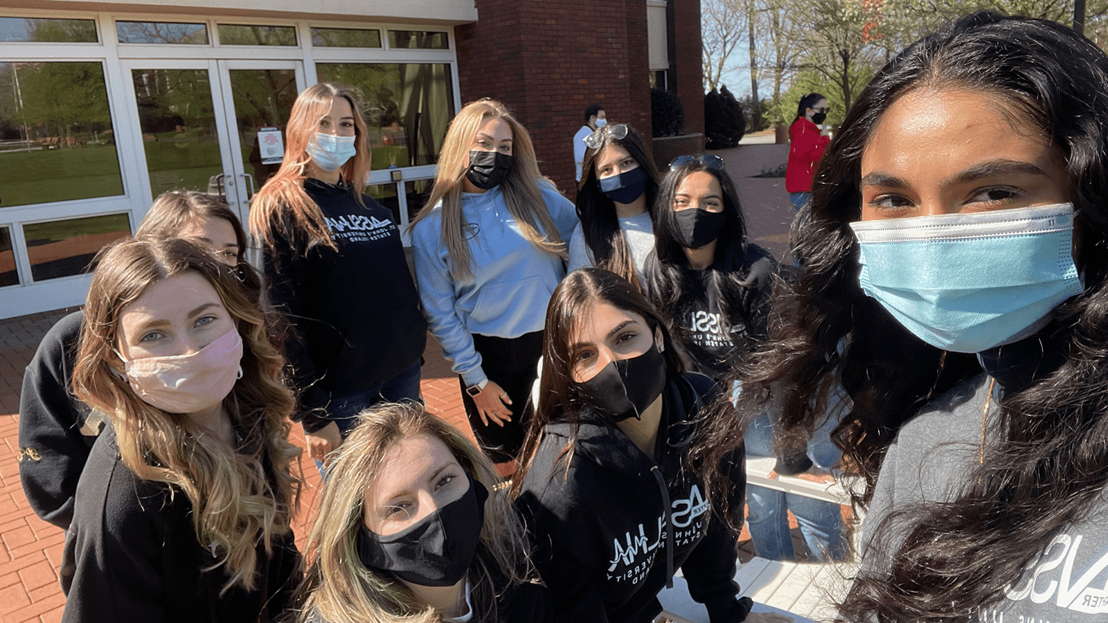 Staten Island Chapter of NSSLHA poses for a picture in front of Kelleher Center