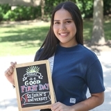 Danicha María Vásquez Pacheco with mini chalkboard