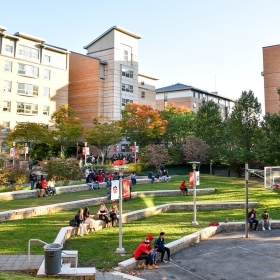 Students at outdoor basketball courts next to Residence buildings