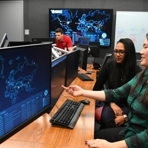 Three students working on computers in SJU Cyber Security Lab