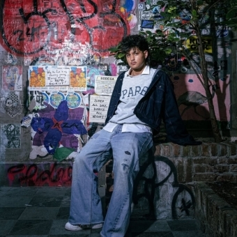 Student photo behind a graffiti wall 