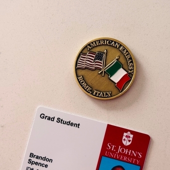 Student id next to US embassy badge