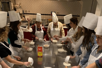 Students cooking around table