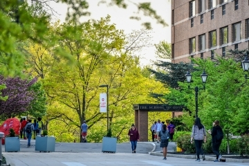 Exterior of School of Ed Building with Students Walking Out Front