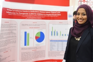 Female standing infront of research poster