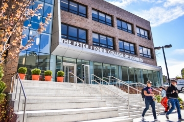 Exterior shot of Peter J. Tobin College of Business with students walking down the stairs
