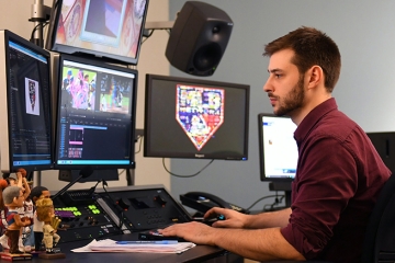 Ryan Gilbert sitting at his desk working on his computer
