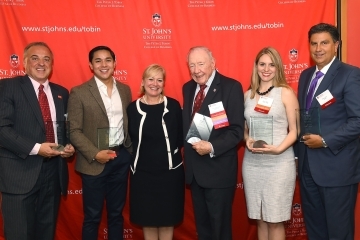 5 award recipients with Dean Sharpe in front of step and repeat.
